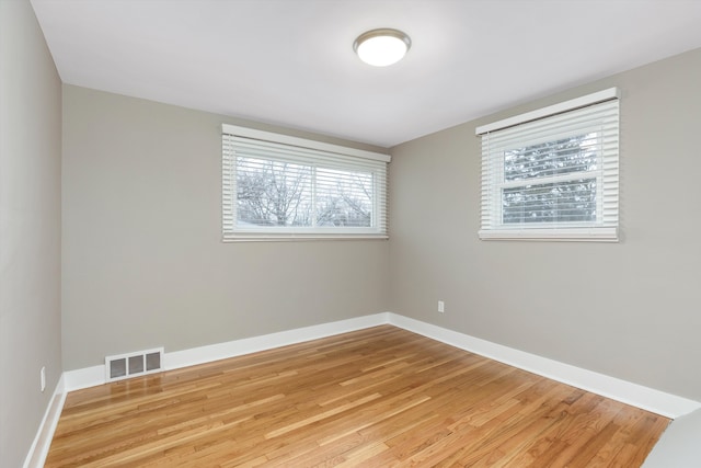 unfurnished room with light hardwood / wood-style flooring