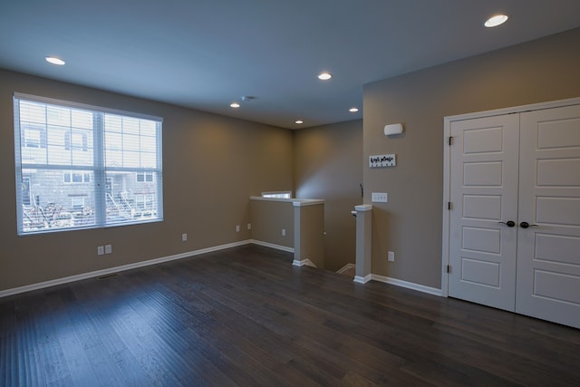 unfurnished room featuring dark wood-type flooring