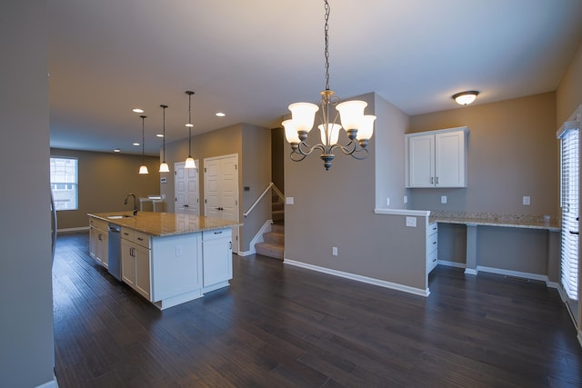 kitchen with dishwasher, light stone counters, white cabinets, a center island with sink, and decorative light fixtures