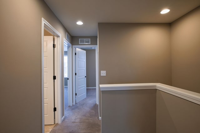 corridor with light colored carpet