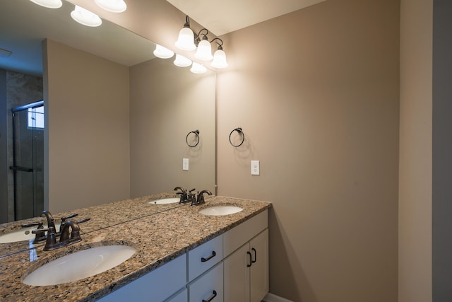 bathroom with vanity and a shower with shower door