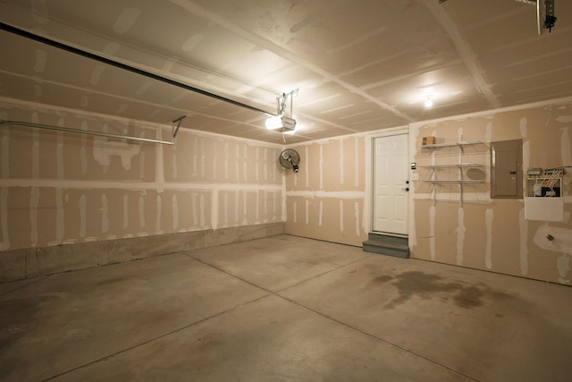 garage with a garage door opener and electric panel