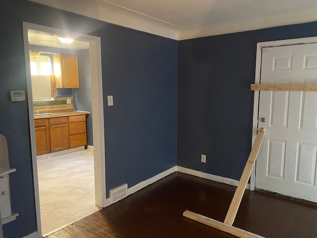 empty room featuring sink and light wood-type flooring