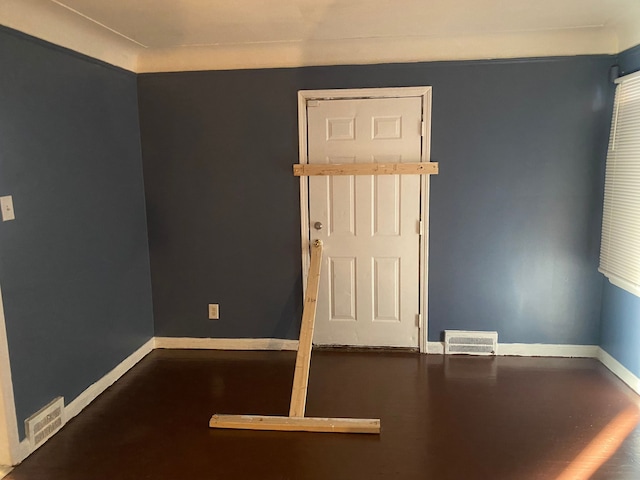 unfurnished room with hardwood / wood-style flooring