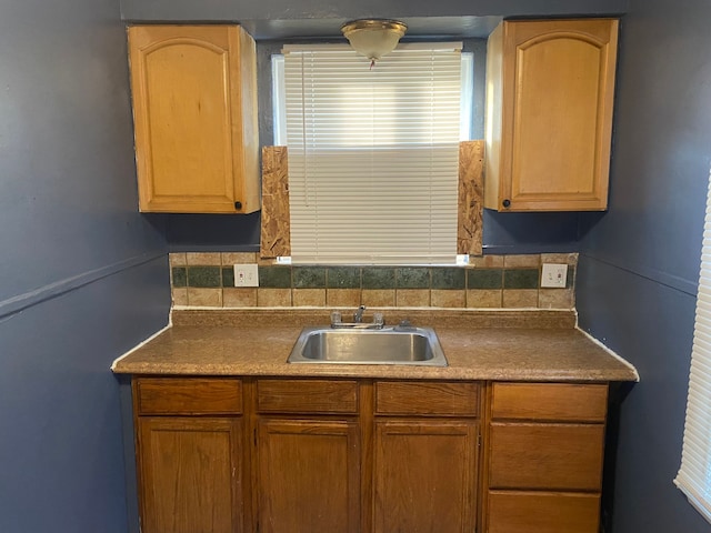 kitchen featuring sink and backsplash