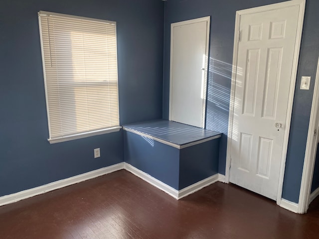 unfurnished bedroom featuring dark wood-type flooring