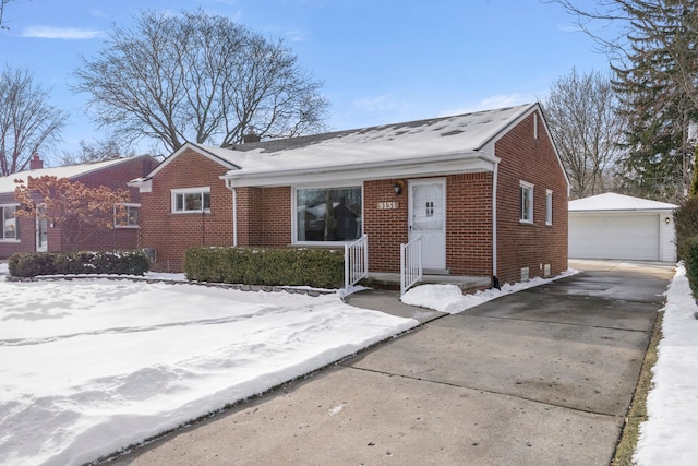 view of front of home featuring a garage and an outbuilding