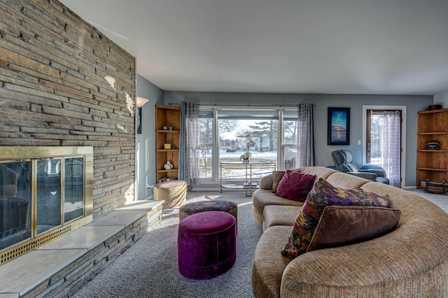 living room featuring carpet floors and a large fireplace