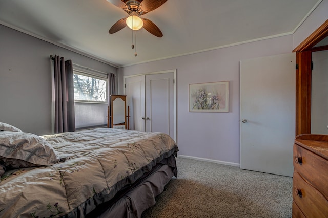 carpeted bedroom featuring ornamental molding, ceiling fan, and a closet