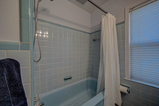 bathroom featuring shower / bath combo with shower curtain