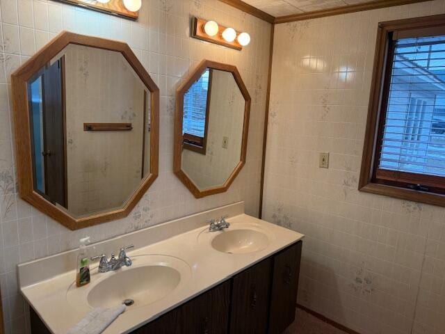 bathroom featuring vanity and tile walls
