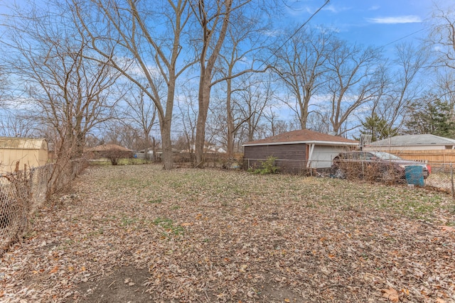 view of yard featuring an outbuilding and a garage