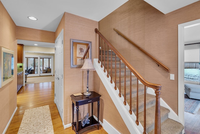 stairs with hardwood / wood-style flooring