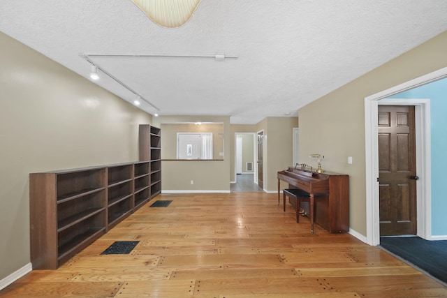 interior space with wood-type flooring and a textured ceiling