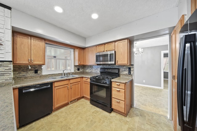 kitchen with sink, black appliances, a textured ceiling, stone countertops, and decorative backsplash