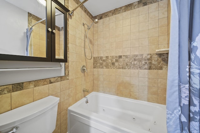 bathroom featuring shower / bath combination with curtain, toilet, and tile walls