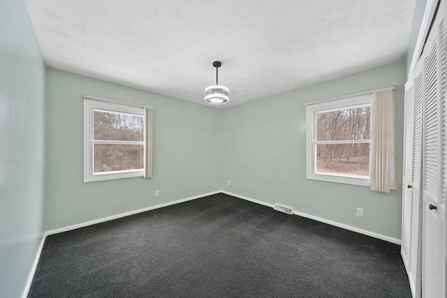 carpeted spare room with a wealth of natural light