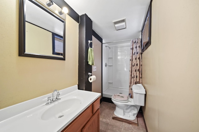 bathroom with vanity, curtained shower, tile patterned floors, and toilet