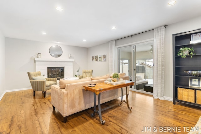 living room featuring a fireplace and light hardwood / wood-style flooring