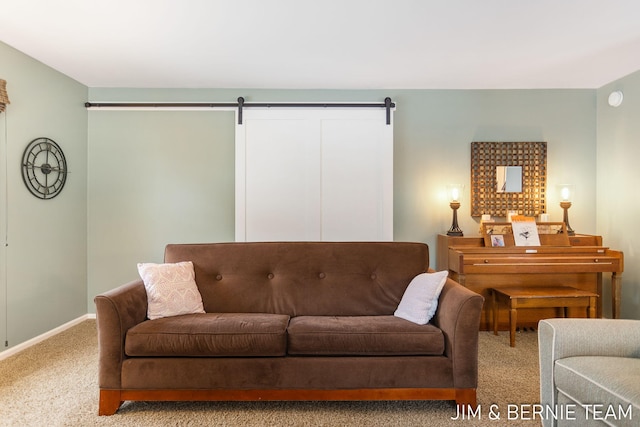 living room featuring a barn door and light colored carpet