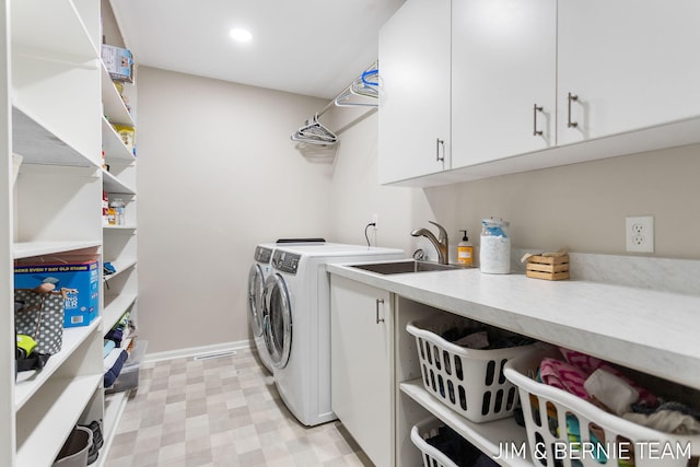 laundry room with cabinets, separate washer and dryer, and sink