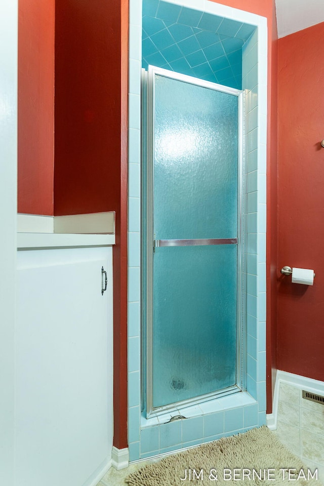 bathroom featuring an enclosed shower and tile patterned flooring