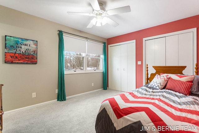 carpeted bedroom featuring multiple closets and ceiling fan