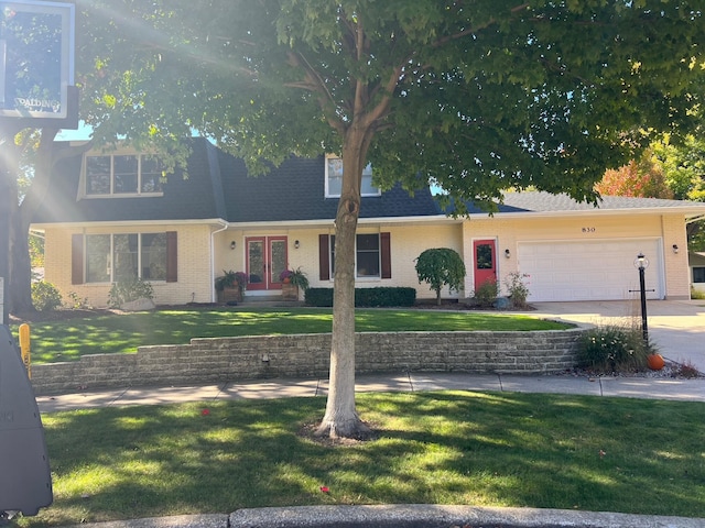 view of front of home featuring a garage and a front lawn