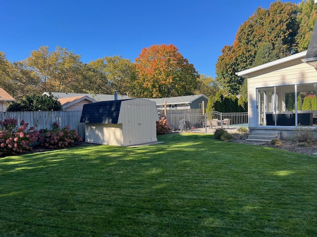 view of yard with a storage shed and a sunroom