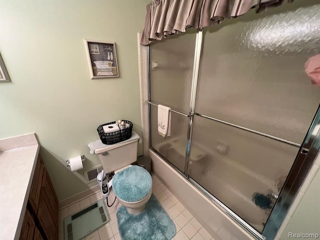 full bath featuring visible vents, toilet, enclosed tub / shower combo, vanity, and tile patterned flooring