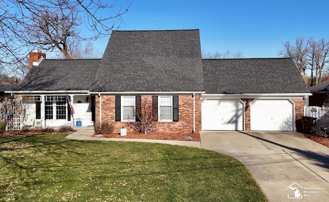 view of front of house featuring a garage and a front lawn