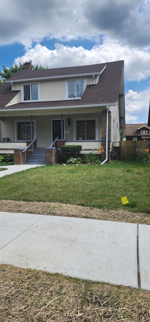 view of front of property featuring a front lawn and a porch