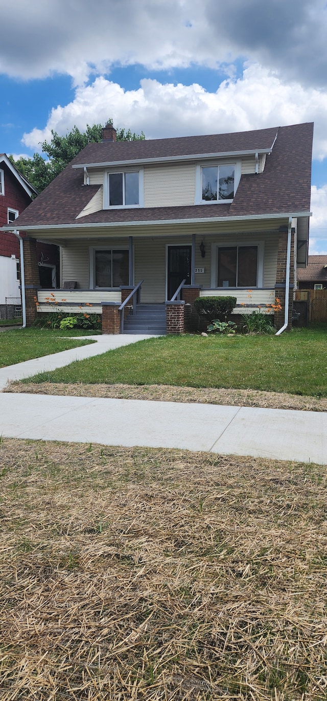 view of front of house featuring a porch and a front lawn