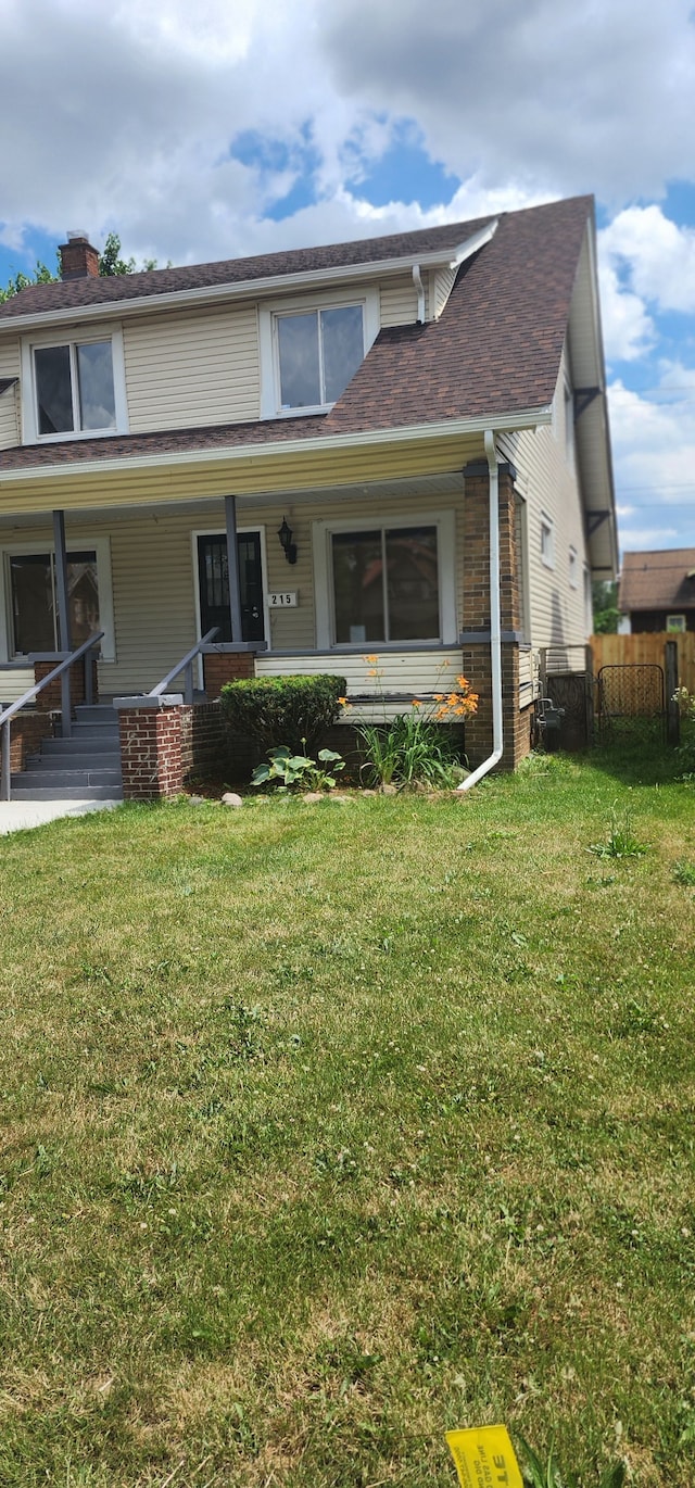 view of front of home featuring a front yard and covered porch