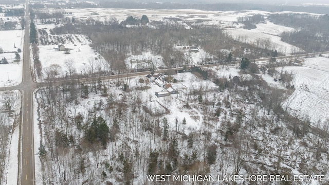 snowy aerial view featuring a rural view