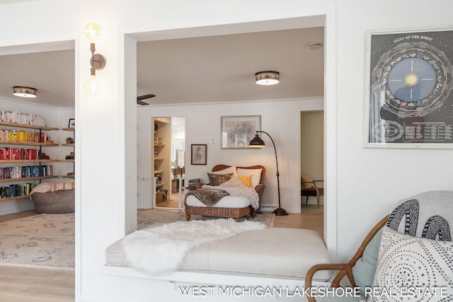 bedroom featuring ornamental molding and light wood-type flooring