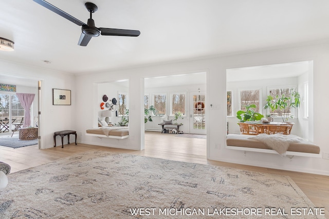 foyer entrance with ceiling fan and light hardwood / wood-style floors