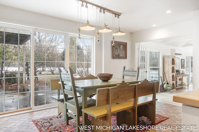 dining space featuring an AC wall unit