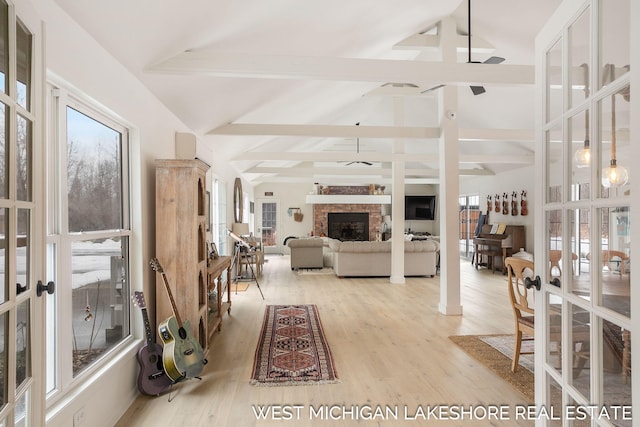 living room with vaulted ceiling with beams, french doors, and ceiling fan