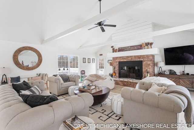 living room featuring ceiling fan, high vaulted ceiling, beam ceiling, and light hardwood / wood-style floors