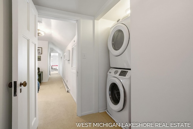 laundry area featuring a baseboard radiator, stacked washer / drying machine, and light carpet