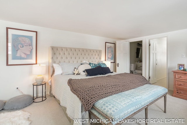 bedroom featuring light colored carpet and connected bathroom