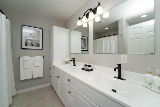 bathroom featuring tile patterned flooring and vanity