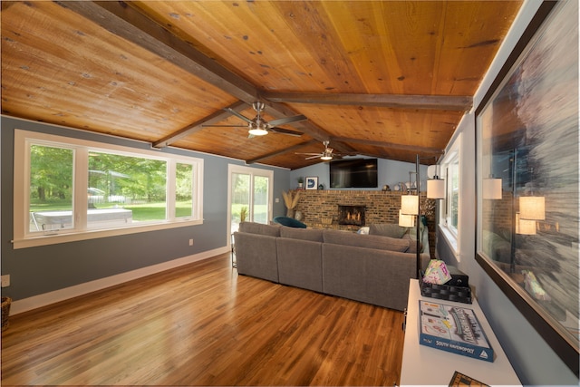 living room featuring vaulted ceiling with beams, wood ceiling, a fireplace, and wood-type flooring