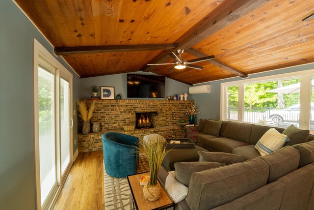 living room with vaulted ceiling with beams, wood ceiling, a wall mounted air conditioner, a brick fireplace, and light wood-type flooring