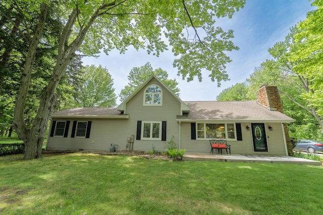 back of house with a lawn