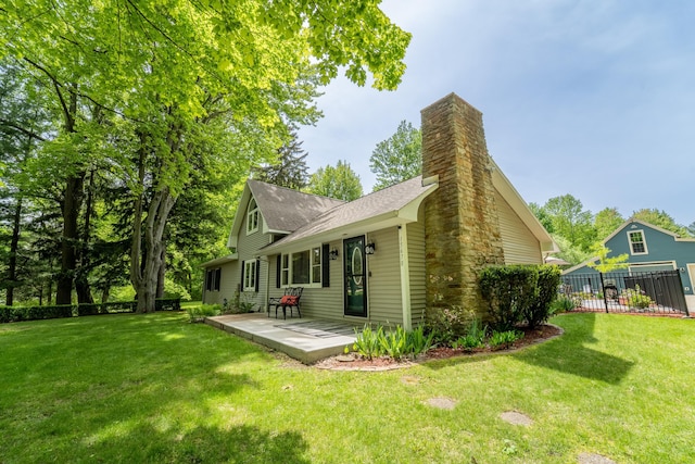 back of property featuring a yard and a patio area