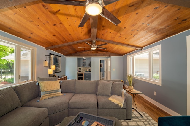 living room featuring plenty of natural light, light hardwood / wood-style floors, lofted ceiling with beams, and wooden ceiling