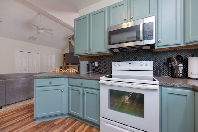 kitchen with white range with electric stovetop, lofted ceiling, backsplash, ceiling fan, and light hardwood / wood-style flooring