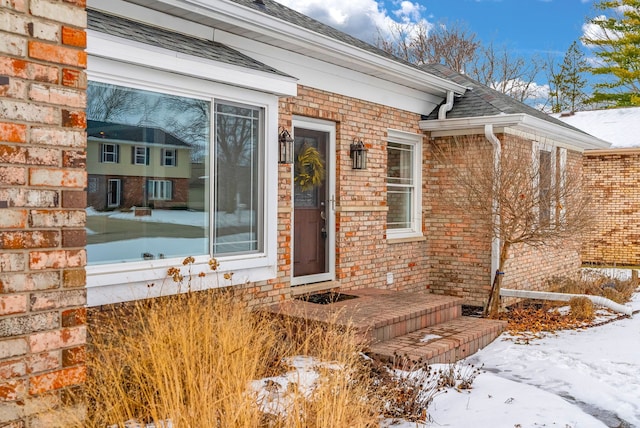 view of snow covered property entrance